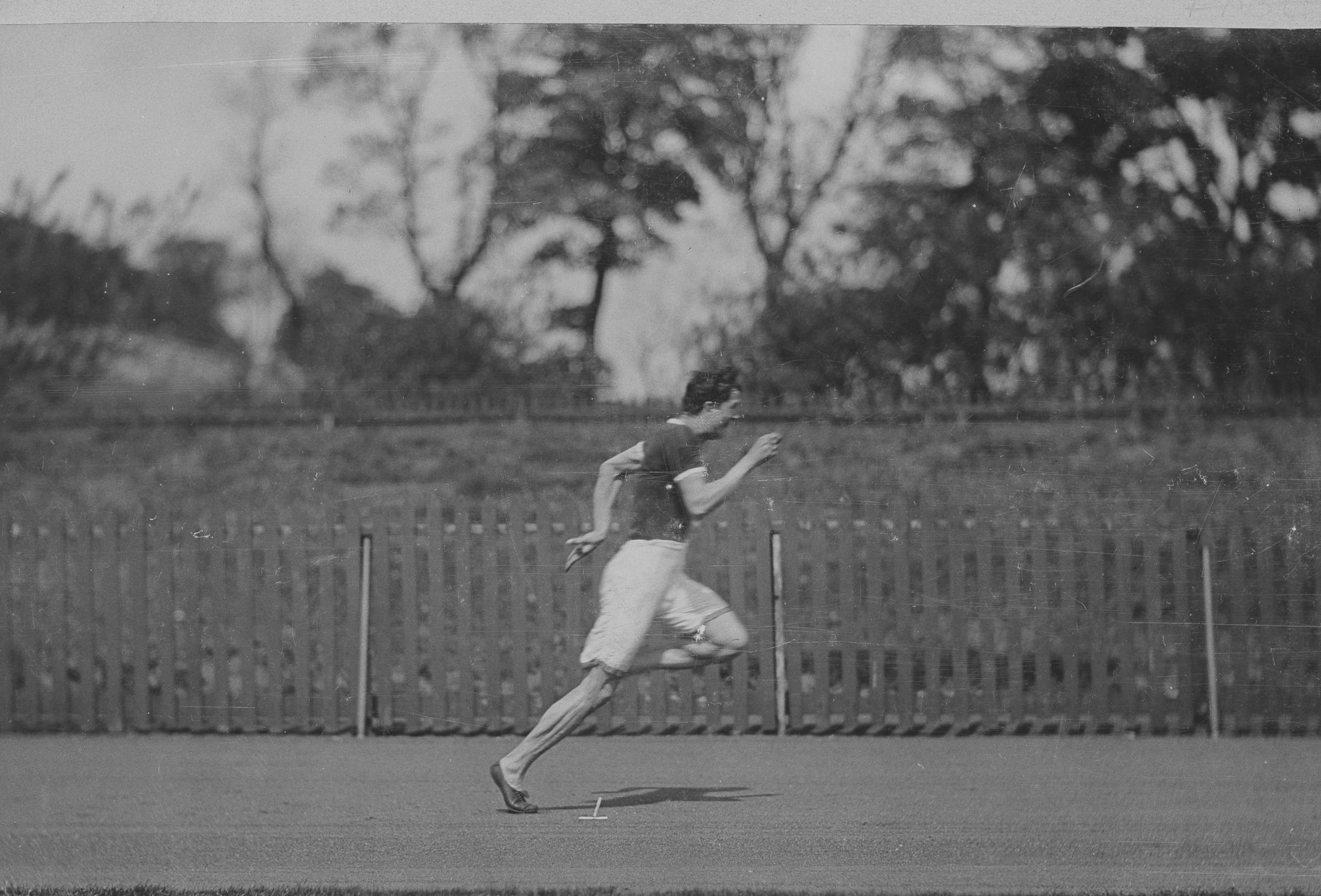 A vintage photograph of a sprinter at full stride