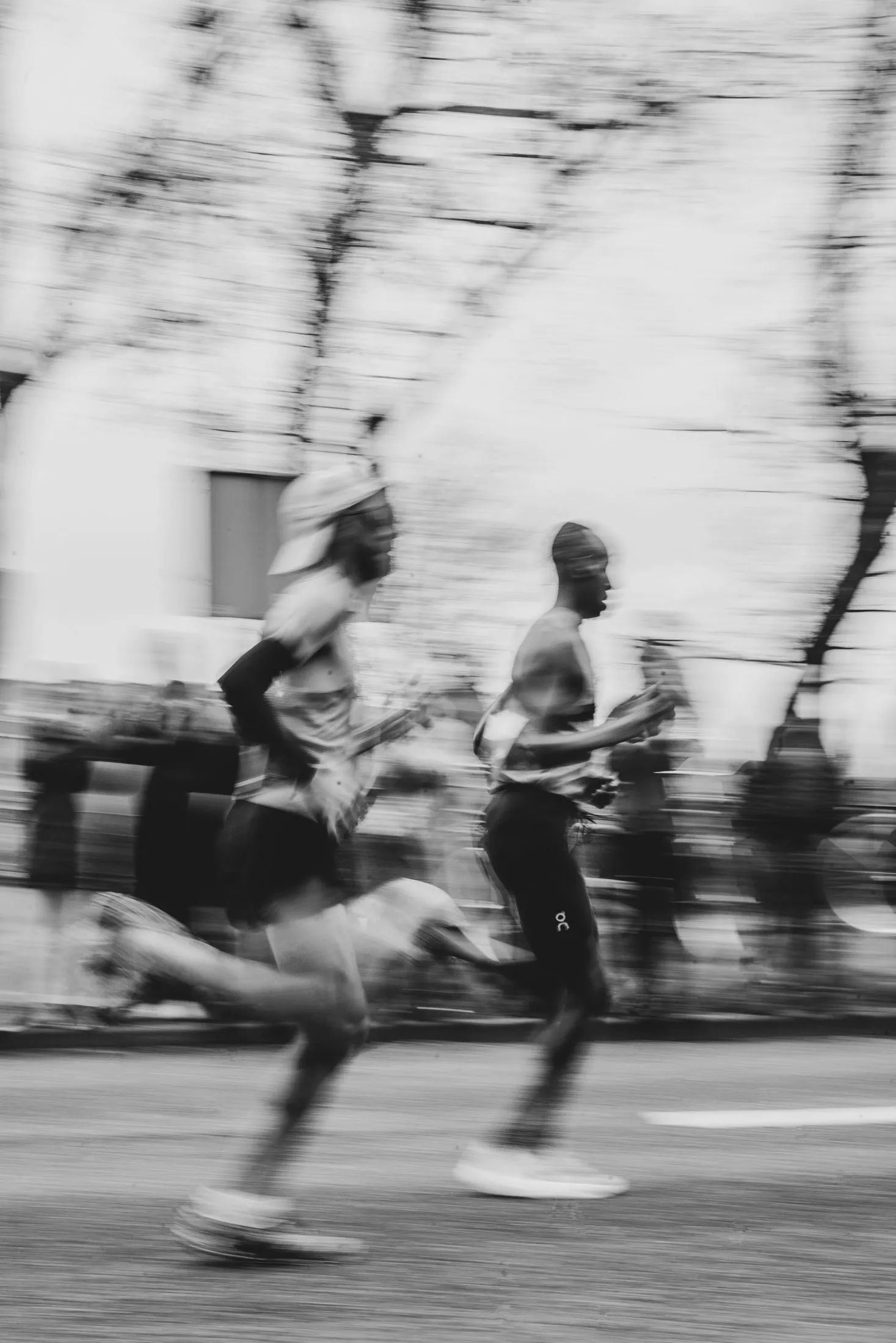 Runners in full stride during a city race, motion blurred